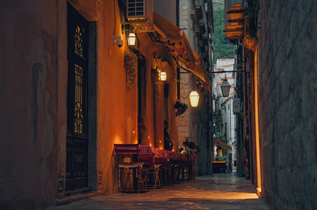 Quiet old city street at dusk with warm lights